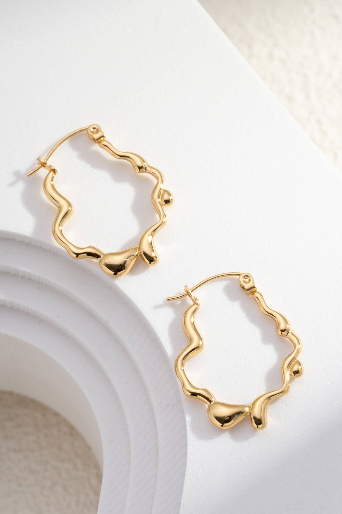 Golden Sculpted Wavy Stainless Steel Creoles Design
